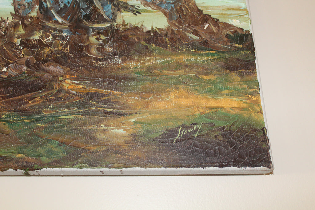 Close-up of a textured surface with artistic brush strokes and a signature.