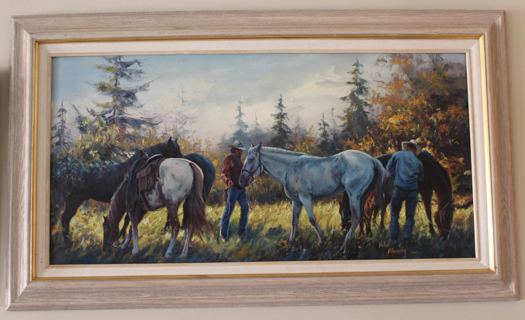 Framed painting of western cowboys with horses in a Yellowstone setting